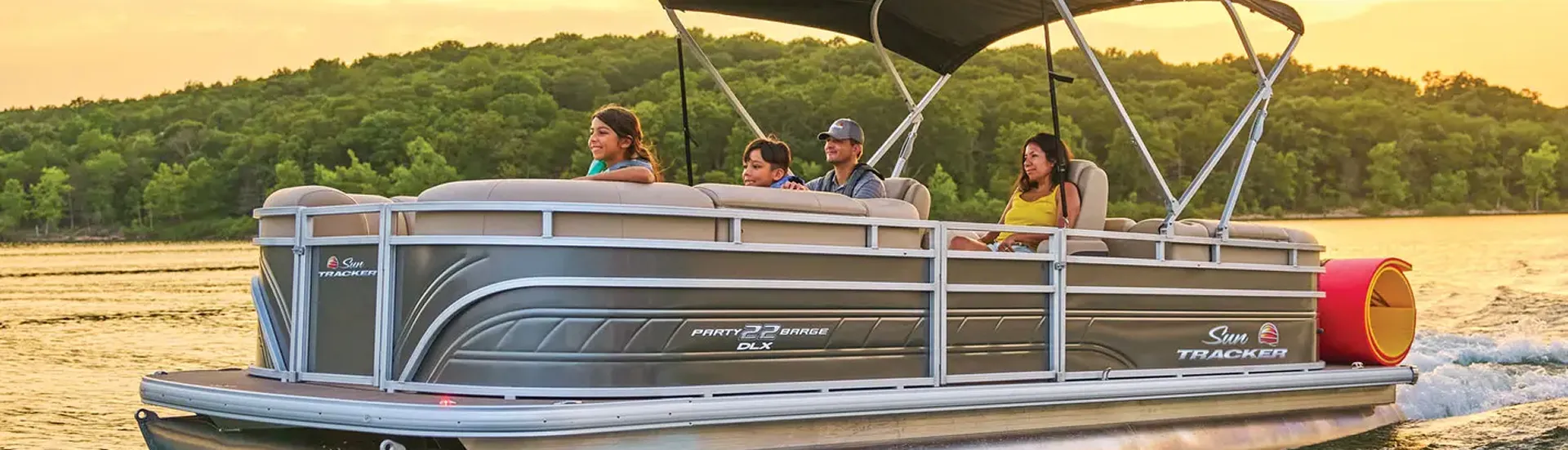 Family on to a big brown boat sailing on sunset sea